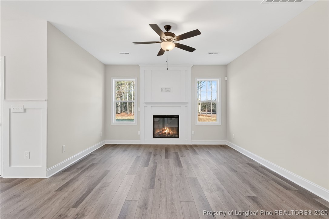 2154 Montrose (lot 6) Road Raeford, NC 28376 - Photo 9 of 44 a view of an empty room with wooden floor and a fireplace