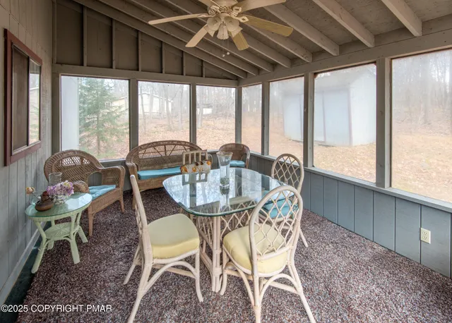 a dining room with furniture a rug and a large window
