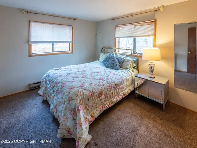 a bed sitting in a bedroom next to a window