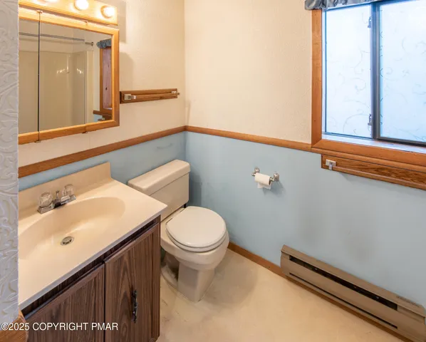 a bathroom with a sink a toilet and mirror