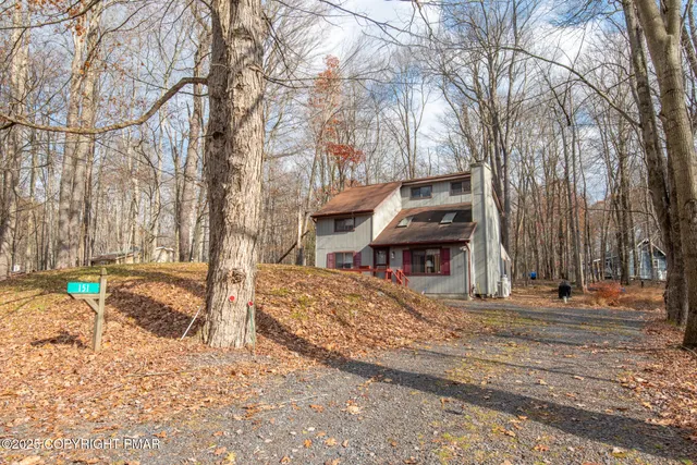 a view of a house with snow on the road