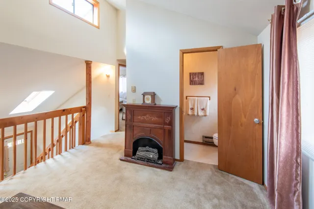 a view of livingroom with furniture and a fireplace