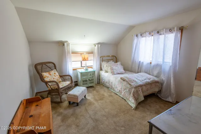 a bedroom with a bed chair and window