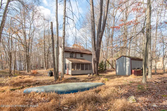 a front view of a building with trees