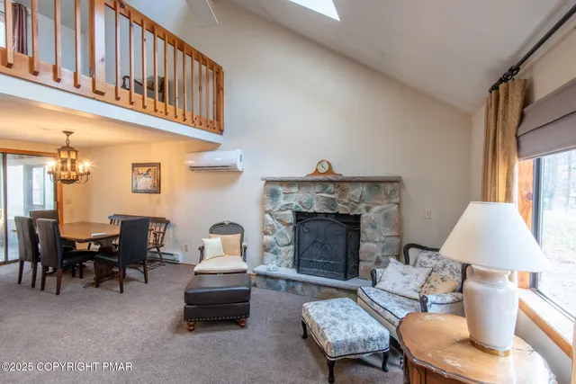a living room with furniture a fireplace and a table