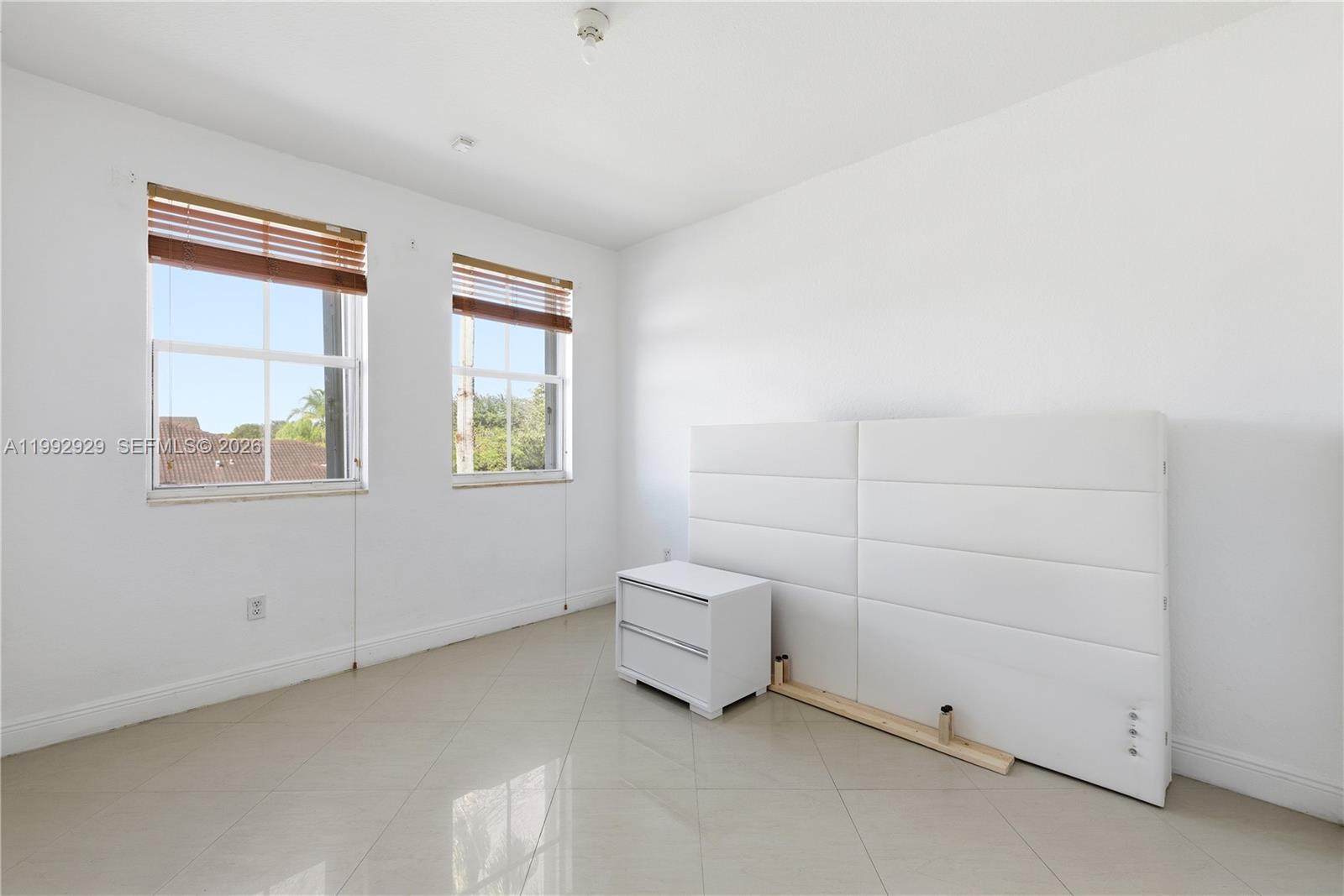 15184 Southwest 20th Street Miami, FL 33185 - Photo 12 of 39 an empty room with a white cabinet and a window