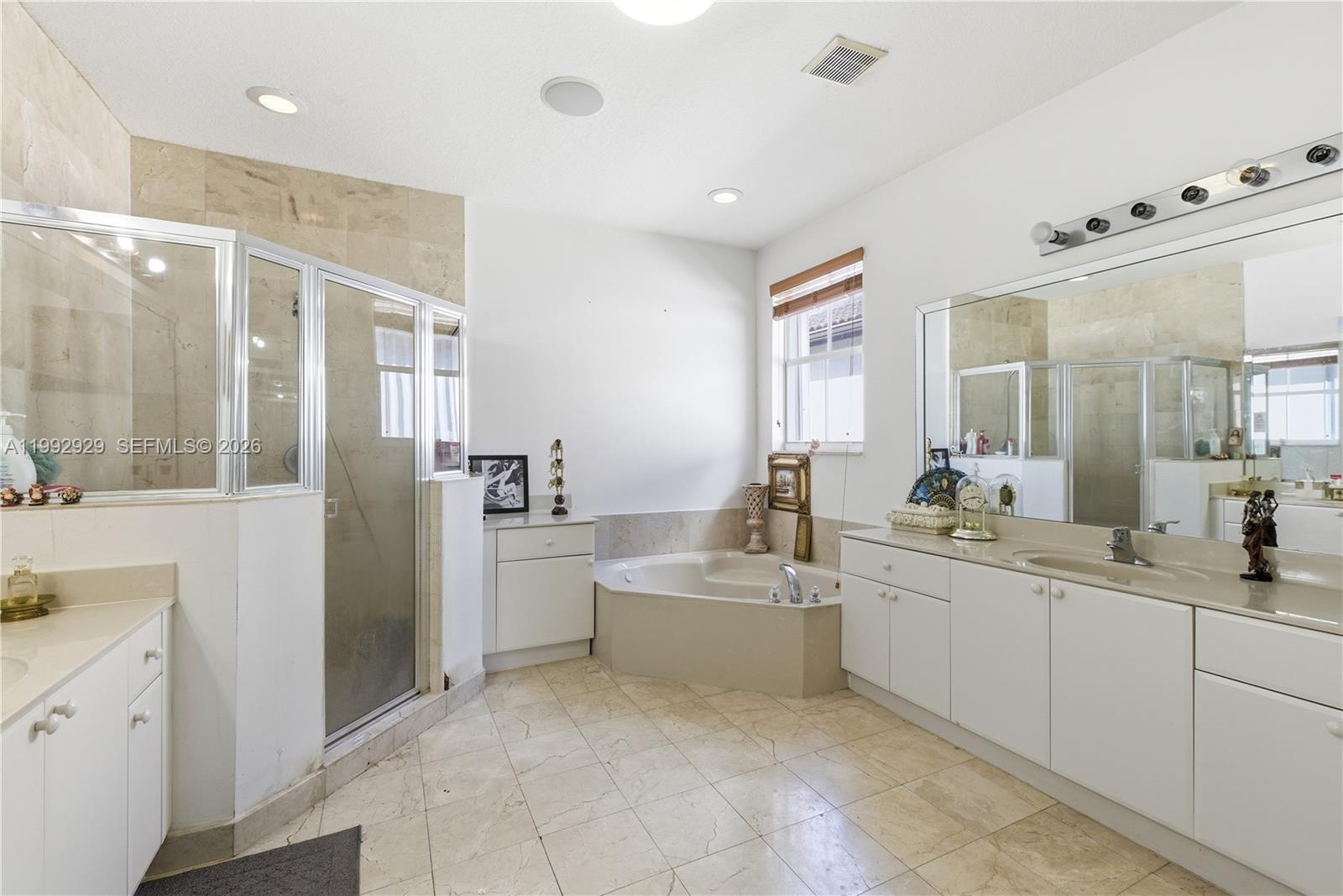 15184 Southwest 20th Street Miami, FL 33185 - Photo 19 of 39 a large bathroom with a double vanity sink a mirror and a shower