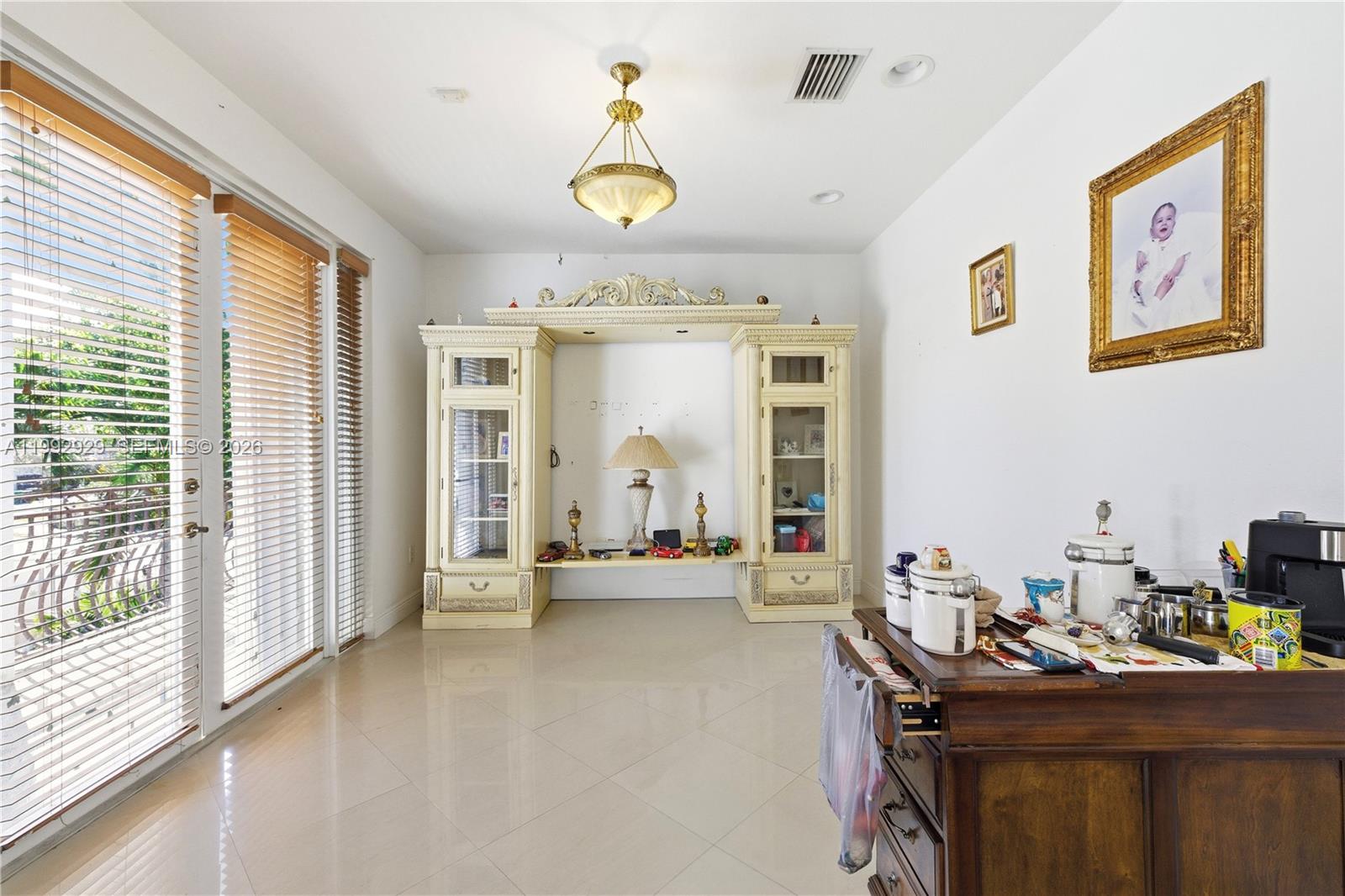 15184 Southwest 20th Street Miami, FL 33185 - Photo 21 of 39 a view of a livingroom with workspace and a window
