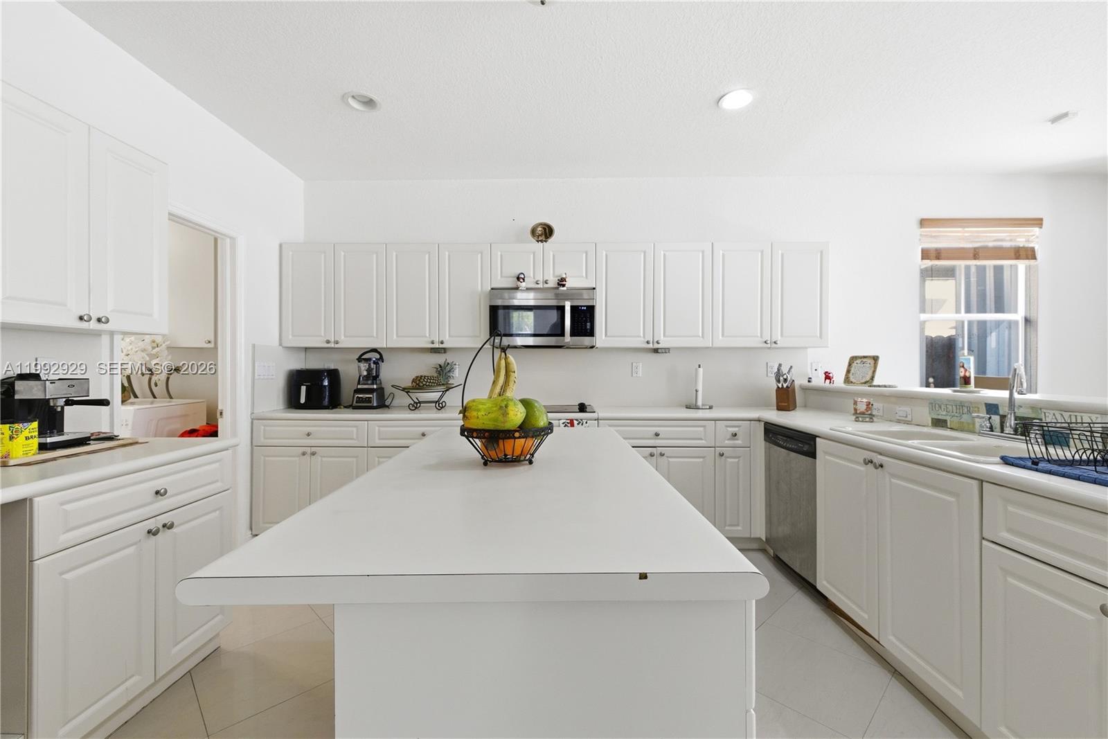 15184 Southwest 20th Street Miami, FL 33185 - Photo 31 of 39 a kitchen that has a sink and cabinets in it