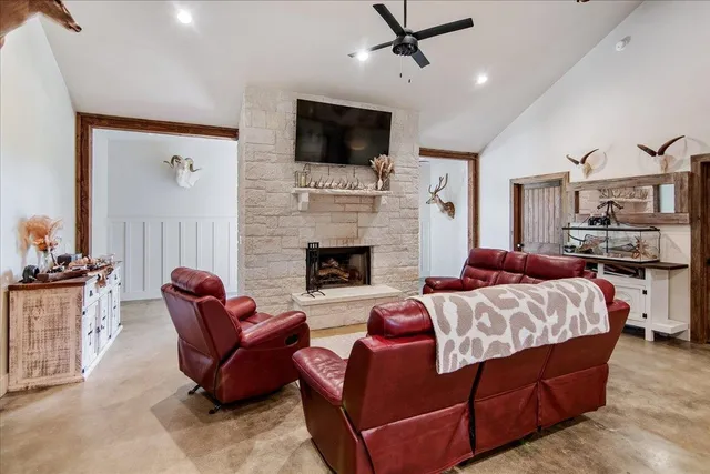 a spacious bedroom with a bed a couch and a flat screen tv