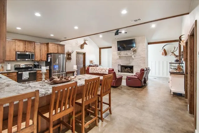 a large kitchen with a table and chairs