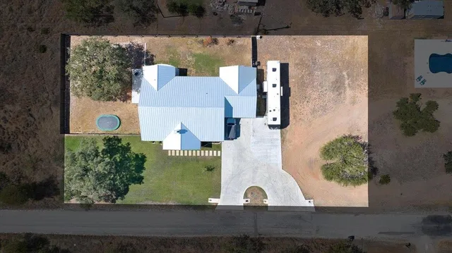 an aerial view of a house with yard