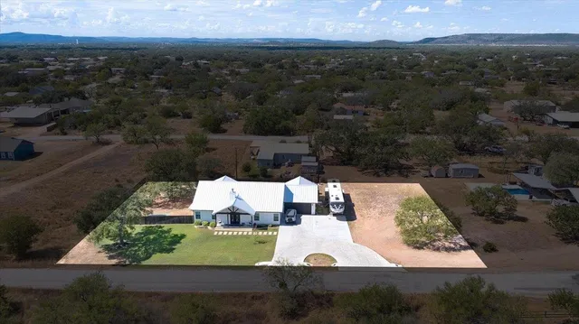 an aerial view of a house with a yard
