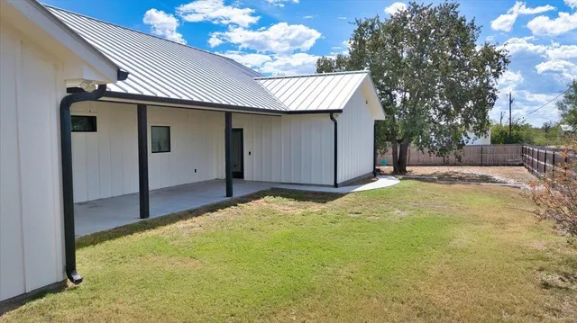 a view of a house with a backyard and garage