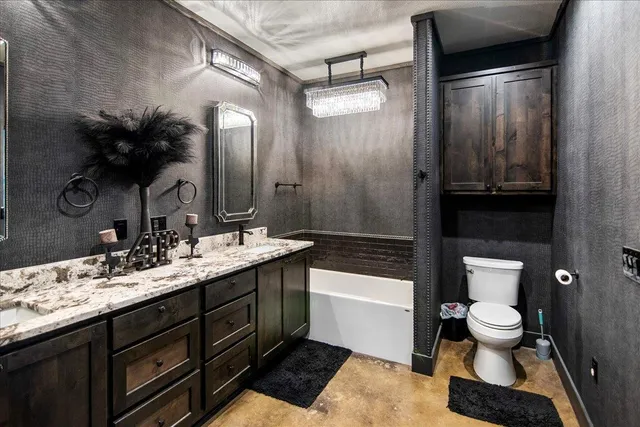 a bathroom with a double vanity sink toilet and shower