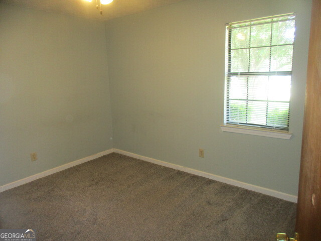625 Strickland Road Locust Grove, GA 30248 - Photo 6 of 11 an empty room with a window