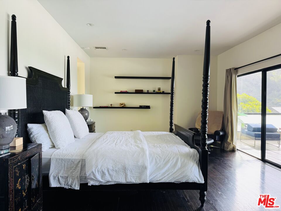 1555 Rising Glen Road Los Angeles, CA 90069 - Photo 11 of 19 a bed room with a bed and large window