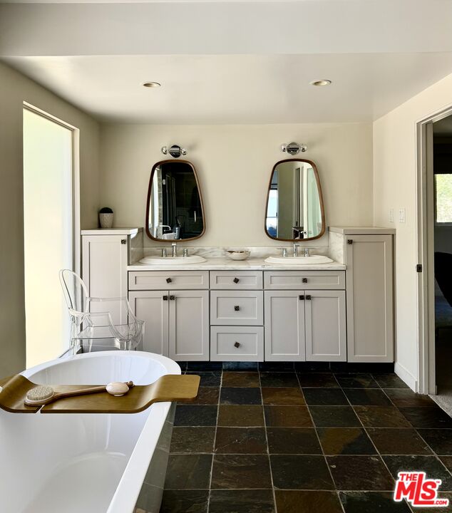1555 Rising Glen Road Los Angeles, CA 90069 - Photo 12 of 19 a bathroom with a sink and a mirror