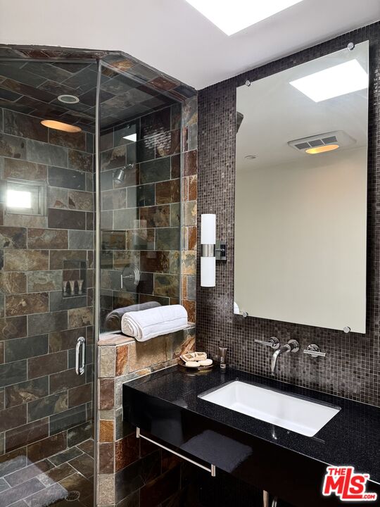 1555 Rising Glen Road Los Angeles, CA 90069 - Photo 15 of 19 a bathroom with a sink and a mirror