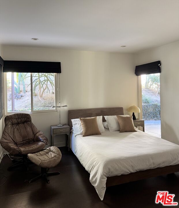 1555 Rising Glen Road Los Angeles, CA 90069 - Photo 18 of 19 a bedroom with a bed and a large window