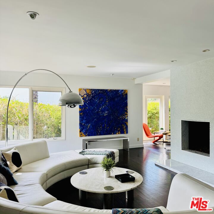1555 Rising Glen Road Los Angeles, CA 90069 - Photo 2 of 19 a living room with furniture and a flat screen tv