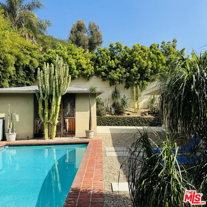 1555 Rising Glen Road Los Angeles, CA 90069 - Photo 3 of 19 a front view of a house with a yard
