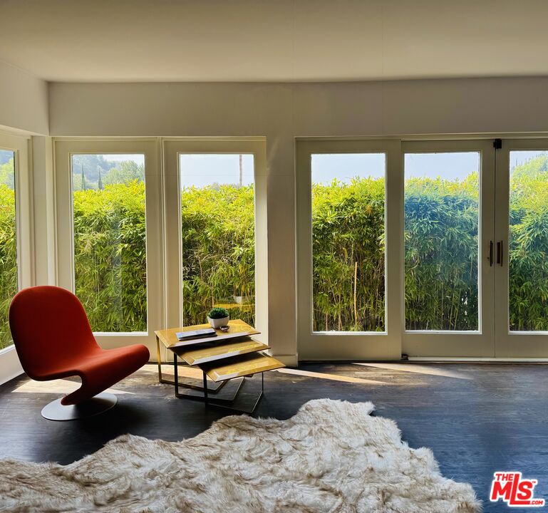 1555 Rising Glen Road Los Angeles, CA 90069 - Photo 6 of 19 a living room with furniture and a floor to ceiling window