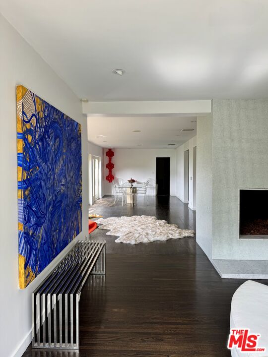 1555 Rising Glen Road Los Angeles, CA 90069 - Photo 7 of 19 a bedroom with a bed and wooden floor