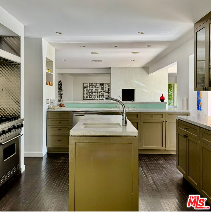 1555 Rising Glen Road Los Angeles, CA 90069 - Photo 9 of 19 a kitchen that has a sink and a stove in it
