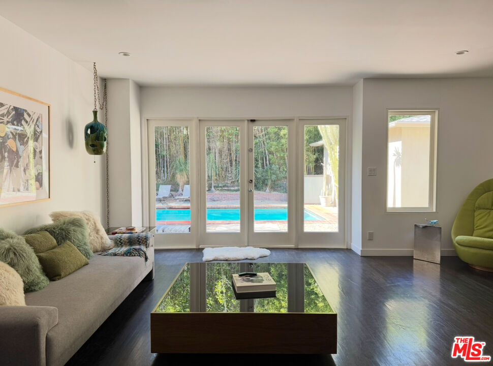 1555 Rising Glen Road Los Angeles, CA 90069 - Photo 10 of 19 a living room with furniture and a flat screen tv