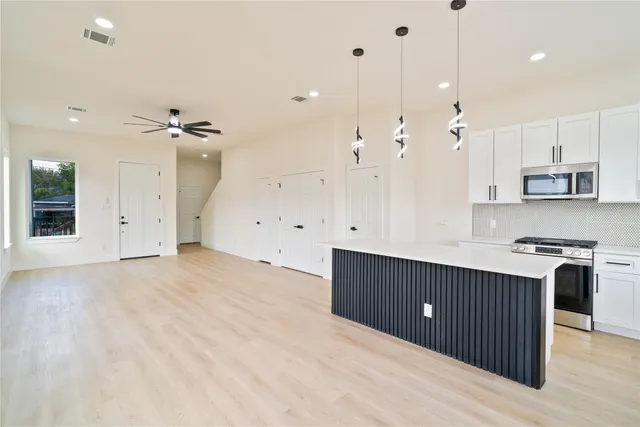 a view of a house with wooden fence