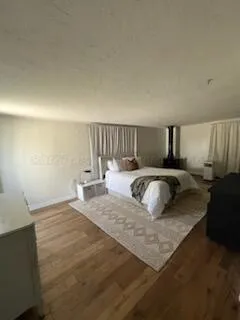 a large bed sitting in a bedroom next to a lamp