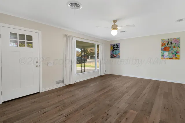 wooden floor in an empty room with a window