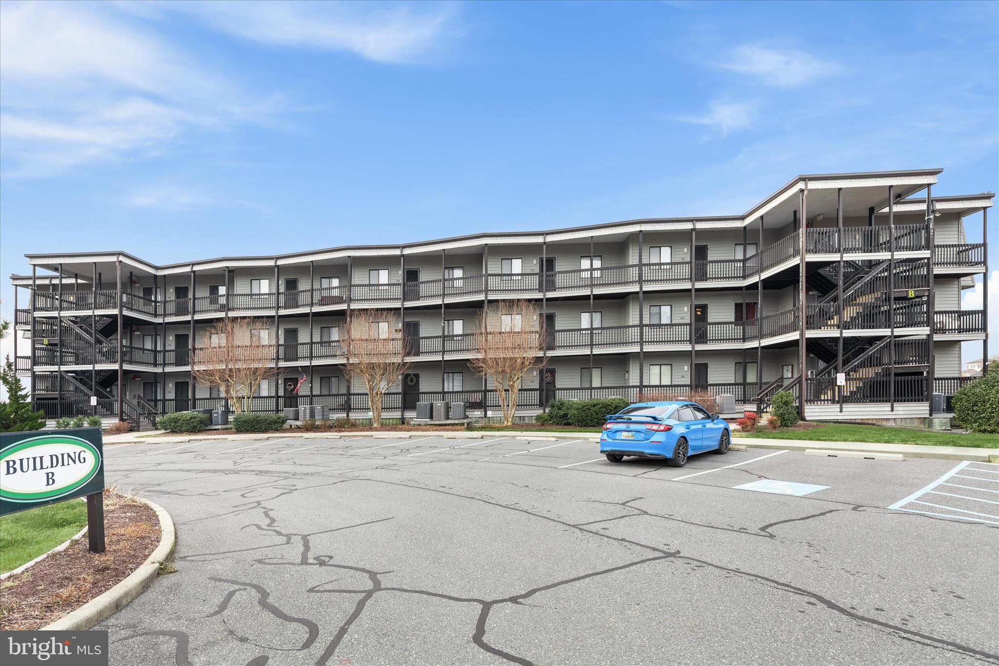 a front view of a building with parking space