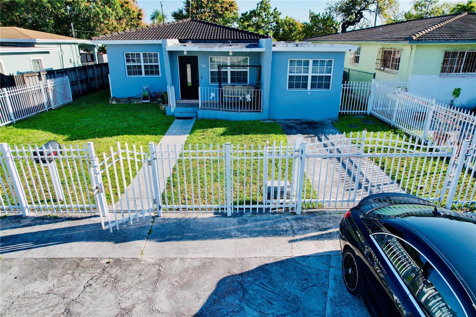 a view of a house with backyard porch and sitting area