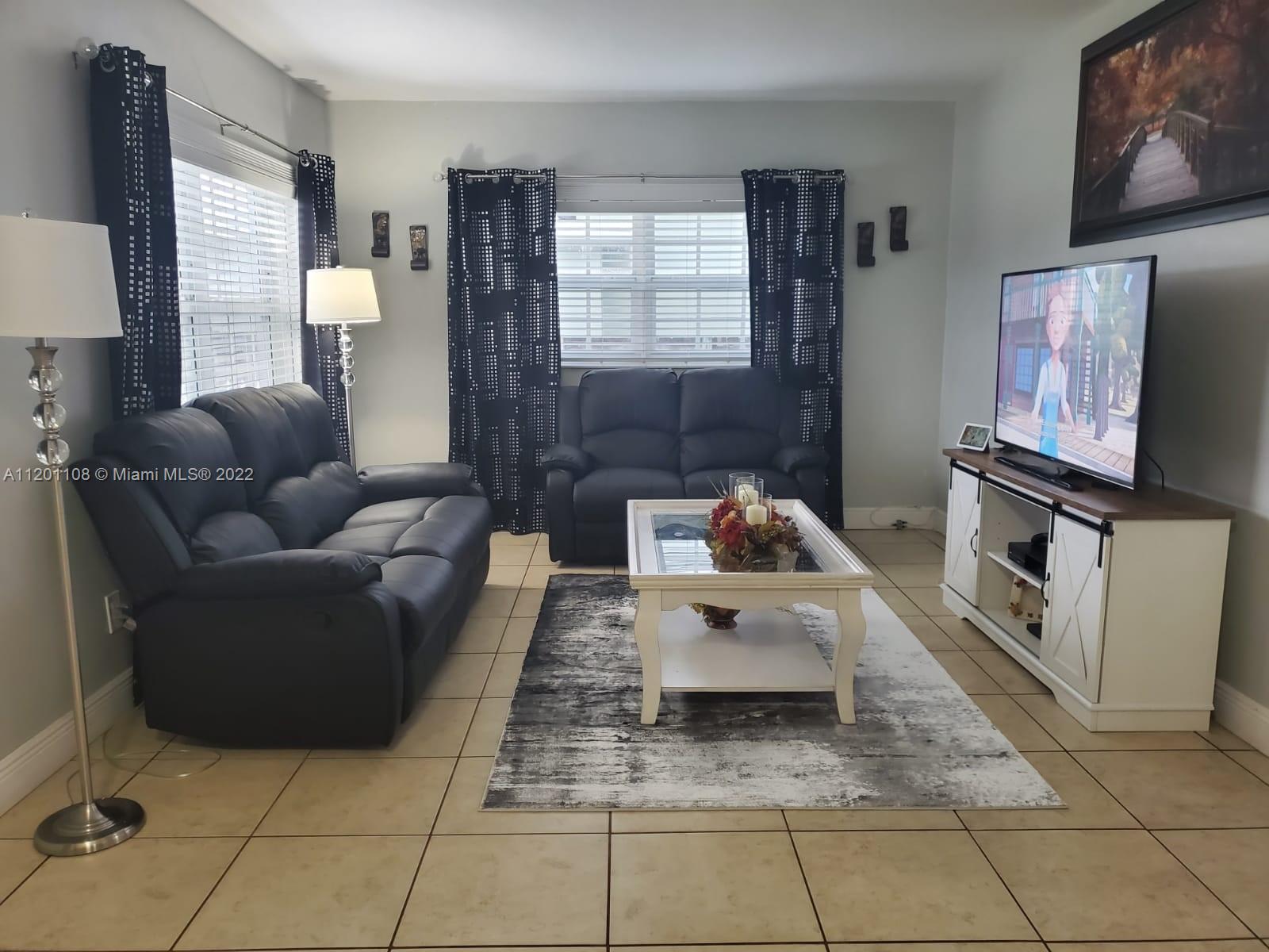 458 Southeast 3rd Street Hialeah, FL 33010 - Photo 3 of 13 a living room with furniture and a flat screen tv