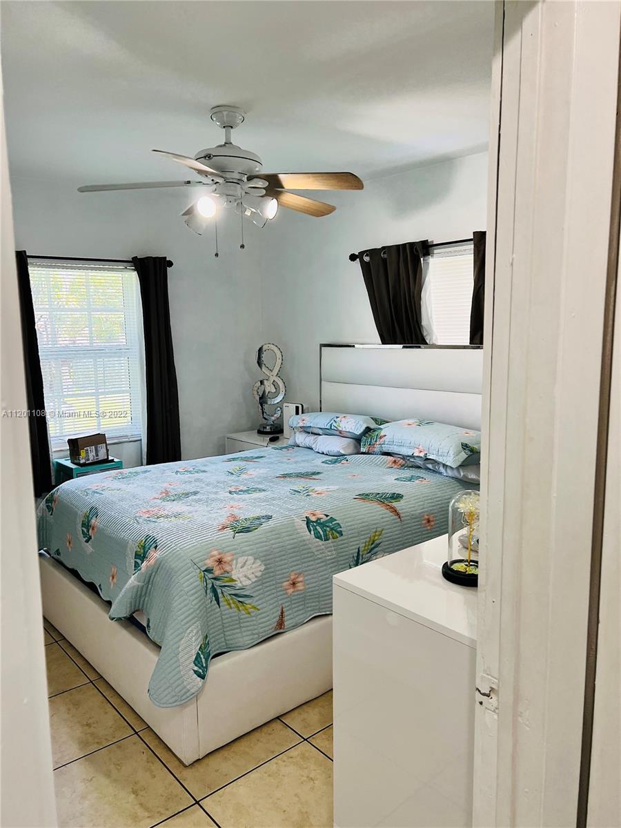 458 Southeast 3rd Street Hialeah, FL 33010 - Photo 10 of 13 a bedroom with a bed and a mirror