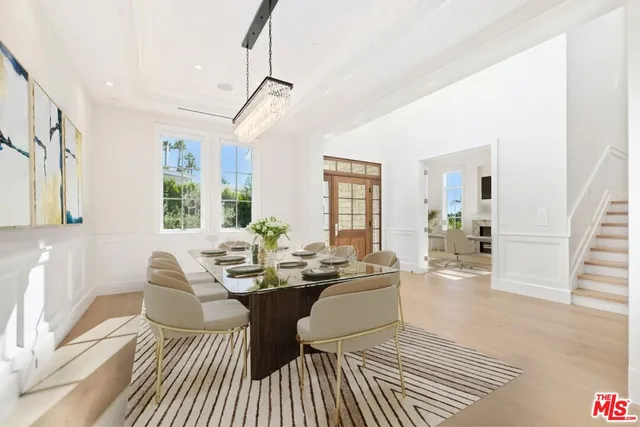 a living room with a couch wooden floor and a table