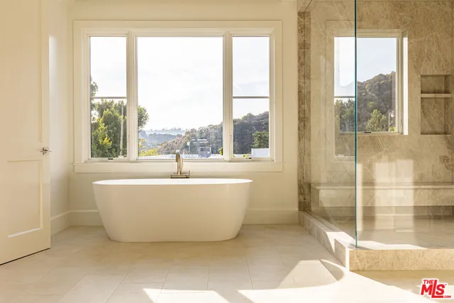 a white bath tub sitting next to a window