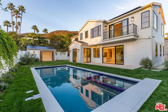 a front view of house with yard and outdoor seating