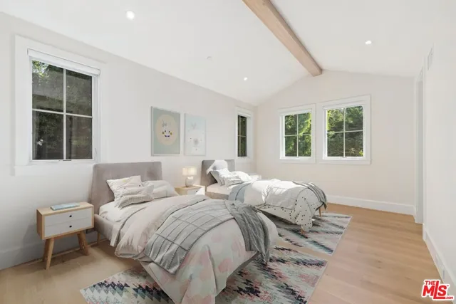 a bedroom with bed and a window