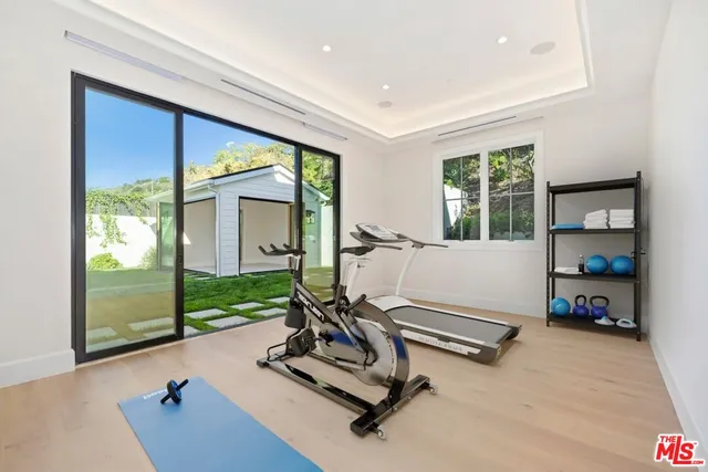 a room with gym equipment and a large window