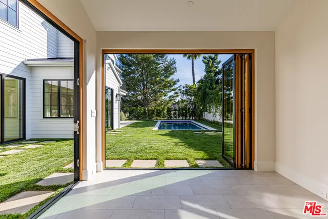 a view of a porch with a floor to ceiling window and a yard