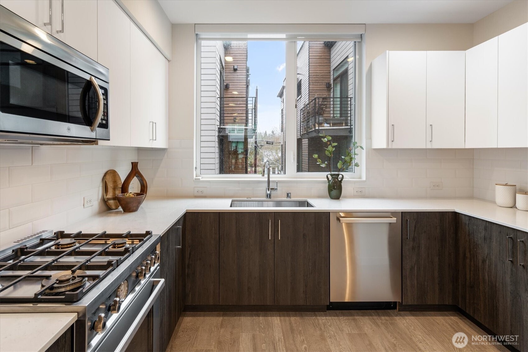 6309 9th Avenue Northeast, Unit D Seattle, WA 98115 - Photo 11 of 28 a kitchen with stainless steel appliances a sink dishwasher stove and microwave