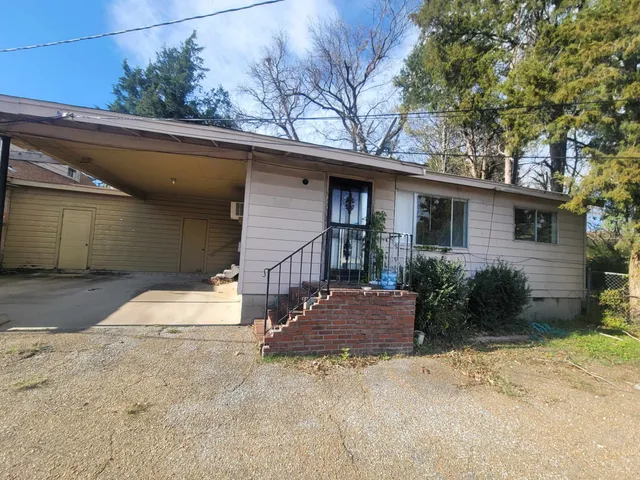 a kitchen with stainless steel appliances granite countertop a stove a sink and a window