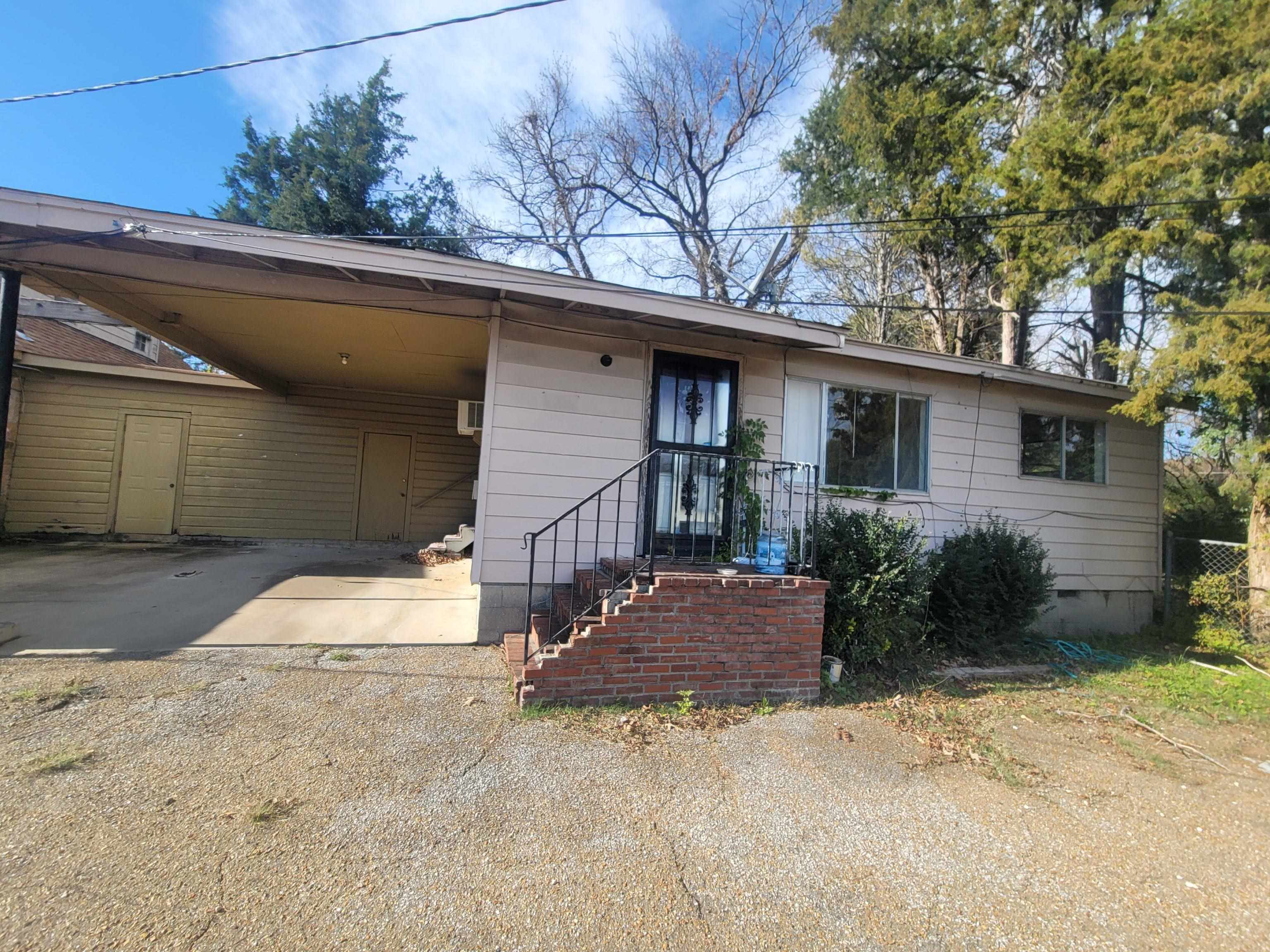 516 East Raines Road Memphis, TN 38109 - Photo 17 of 34 Ranch-style house featuring an attached carport and driveway