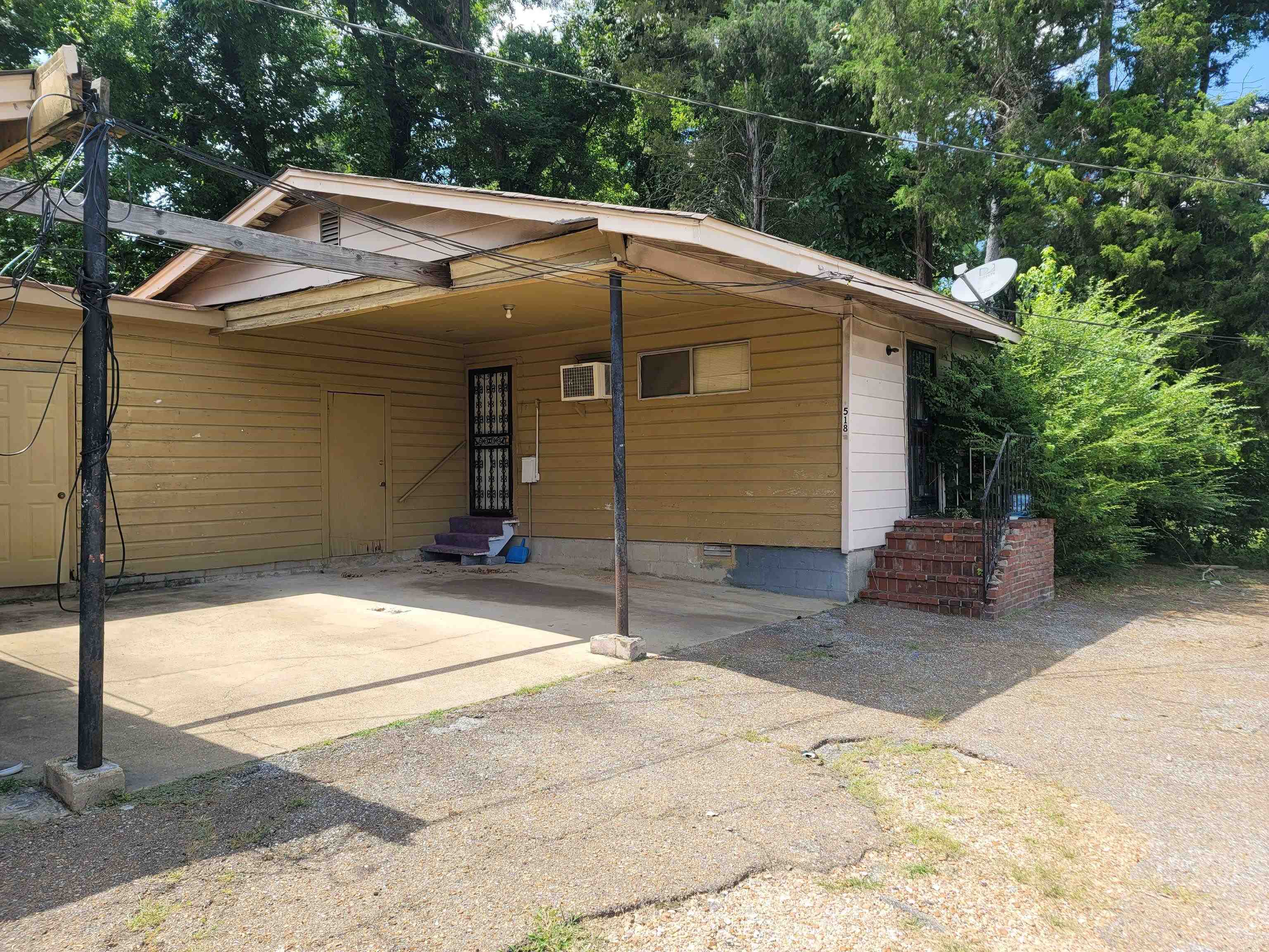 516 East Raines Road Memphis, TN 38109 - Photo 19 of 34 a backyard of a house with portable swimming pool and brick wall