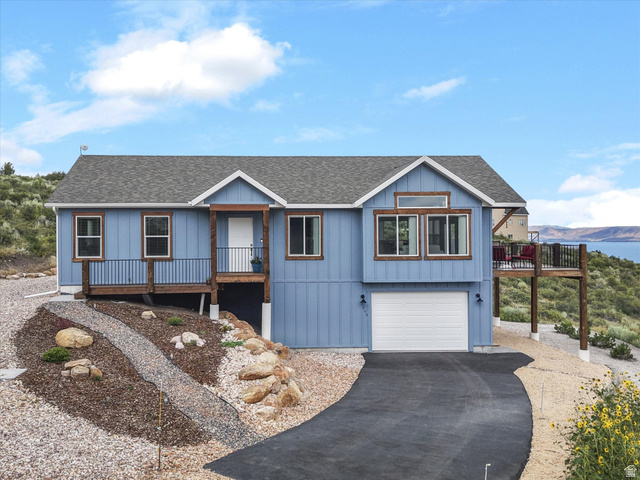 608 Fremont Road Fish Haven, ID 83287 - Photo 35 of 35 Blue horizontal siding exterior with a shingled roof and integrated garage
