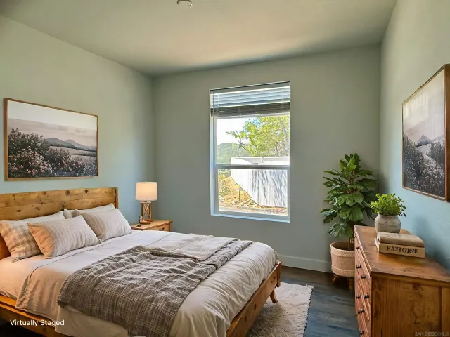 a bedroom with a bed and a potted plant