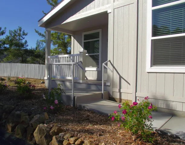 a view of a house with a yard and garden